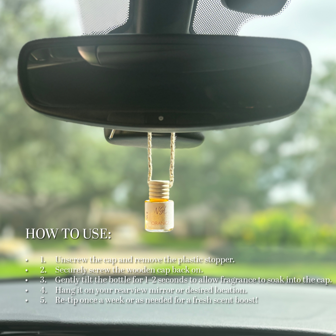 Car air freshener hanging from a car's rearview mirror with usage instructions displayed.