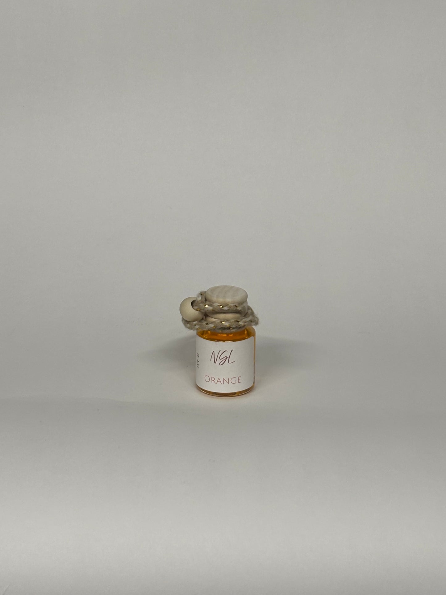 Orange hanging diffuser with a white background