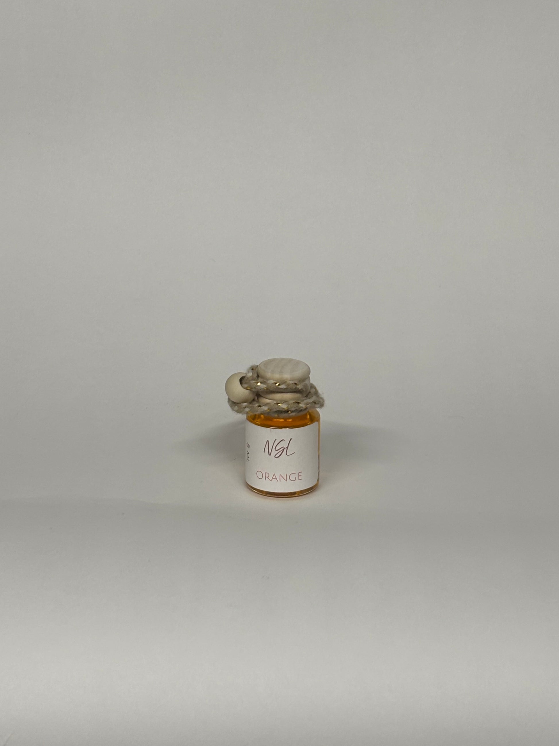 Orange hanging diffuser with a white background