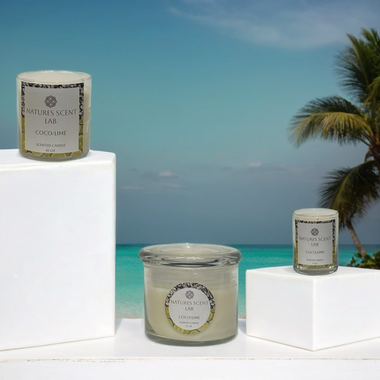 3oz, 10oz and 15oz coco/lime candles on a white platform in front of a tropical background