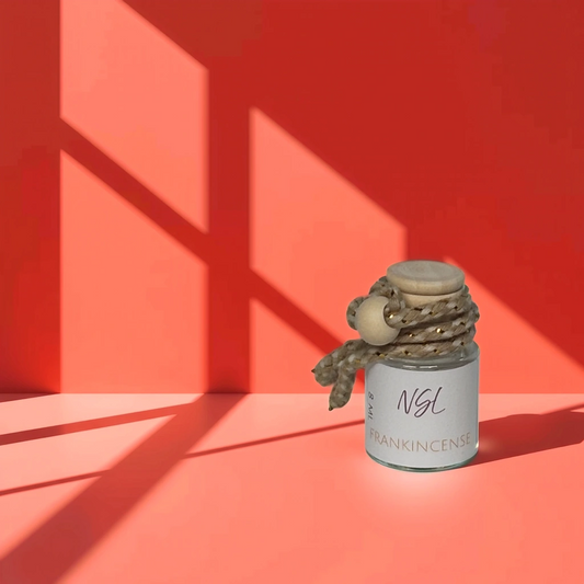 frankincense hanging diffuser with a light red background